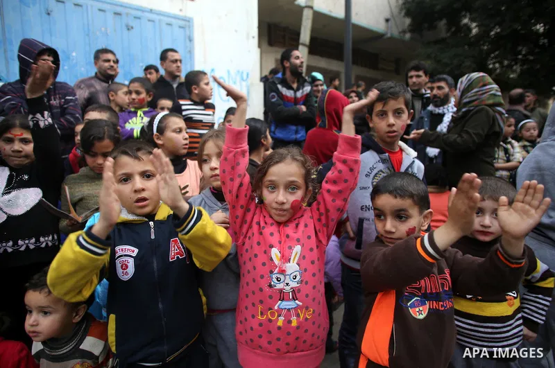 Palestinian children attend a street game organised by volunteers of the Friday of Joy Initiative, in al-Shati refugee camp, in Gaza city, February 6, 2015. Ten Palestinian volunteers organise street games, painting and...