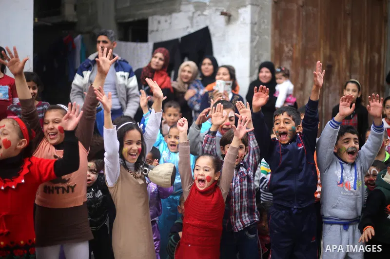 Palestinian children attend a street game organised by volunteers of the Friday of Joy Initiative, in al-Shati refugee camp, in Gaza city, February 6, 2015. Ten Palestinian volunteers organise street games, painting and...