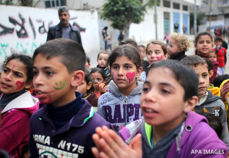 Palestinian children attend a street game organised by volunteers of the Friday of Joy Initiative, in al-Shati refugee camp, in Gaza city, February 6, 2015. Ten Palestinian volunteers organise street games, painting and...