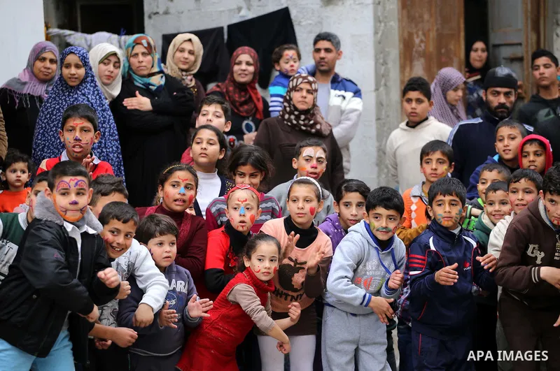 Palestinian children attend a street game organised by volunteers of the Friday of Joy Initiative, in al-Shati refugee camp, in Gaza city, February 6, 2015. Ten Palestinian volunteers organise street games, painting and...