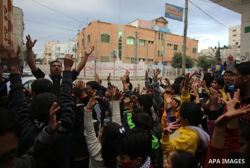 A volunteer of the Friday of Joy Initiative, plays with children in the street in al-Shati refugee camp, in Gaza city, February 6, 2015. Ten Palestinian volunteers organise street games, painting and drama, every Friday...