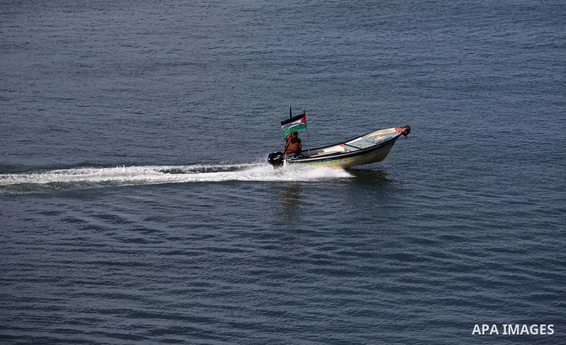 Palestinians ride a boat in the mediterranean sea off the coast of Gaza city on February 7, 2015. The Israeli military boats on Friday morning opened fire on the Palestinian fishermen's boats near Al-Sudaneyya shore nort...