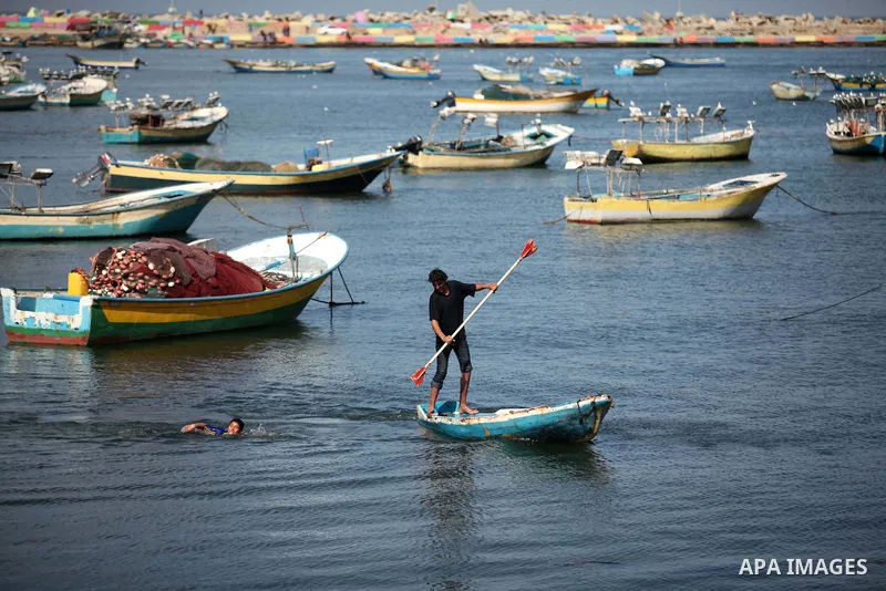 Palestinians enjoy swimming at the Gaza seaport, on February 7, 2015. The Israeli military boats on Friday morning opened fire on the Palestinian fishermen's boats near Al-Sudaneyya shore northwest of Gaza Strip. Photo b...