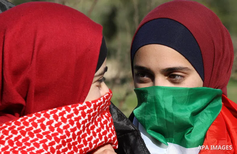 Masked Palestinian girls take part in a protest at the scene where Ahmed al-Najjar by Israeli soldiers on January 30, 2015, in the West Bank village of Burin, near Nablus on February 7, 2015. Local sources said Israeli t...