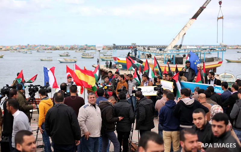 Palestinian students take part in a protest demanding for the opening of a waterway between Gaza Strip and other countries, at the Gaza seaport on February 8, 2015. The governmental Committee to Break the Siege on Gaza d...