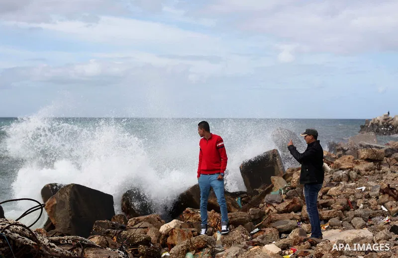 Palestinian youths take photos in front of the beach of Gaza city, on February 8, 2015. The governmental Committee to Break the Siege on Gaza declared last month the beginning of the rehabilitation of a waterway that wou...