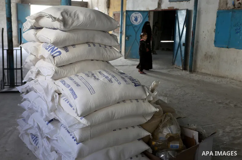 Palestinians receive their monthly food aid at a United Nations distribution center (UNRWA) in the Rafah refugee camp, in southern Gaza Strip on February 8, 2015. UN Secretary General Ban Ki-moon called on Friday for int...