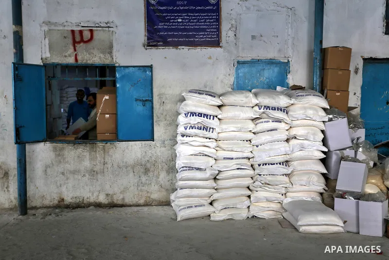 Palestinians receive their monthly food aid at a United Nations distribution center (UNRWA) in the Rafah refugee camp, in southern Gaza Strip on February 8, 2015. UN Secretary General Ban Ki-moon called on Friday for int...