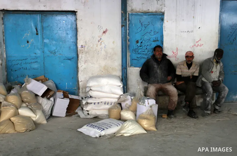 Palestinians receive their monthly food aid at a United Nations distribution center (UNRWA) in the Rafah refugee camp, in southern Gaza Strip on February 8, 2015. UN Secretary General Ban Ki-moon called on Friday for int...
