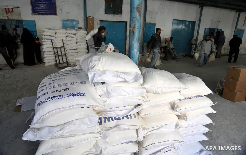 Palestinians receive their monthly food aid at a United Nations distribution center (UNRWA) in the Rafah refugee camp, in southern Gaza Strip on February 8, 2015. UN Secretary General Ban Ki-moon called on Friday for int...