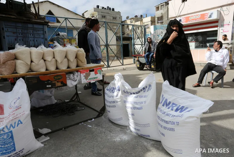 Palestinians receive their monthly food aid at a United Nations distribution center (UNRWA) in the Rafah refugee camp, in southern Gaza Strip on February 8, 2015. UN Secretary General Ban Ki-moon called on Friday for int...