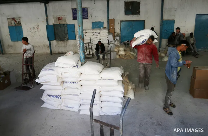 Palestinians receive their monthly food aid at a United Nations distribution center (UNRWA) in the Rafah refugee camp, in southern Gaza Strip on February 8, 2015. UN Secretary General Ban Ki-moon called on Friday for int...