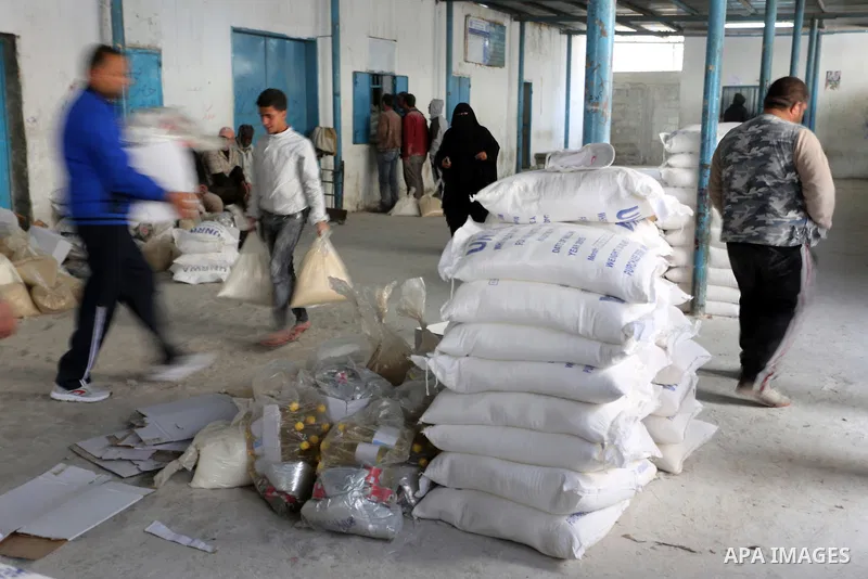 Palestinians receive their monthly food aid at a United Nations distribution center (UNRWA) in the Rafah refugee camp, in southern Gaza Strip on February 8, 2015. UN Secretary General Ban Ki-moon called on Friday for int...