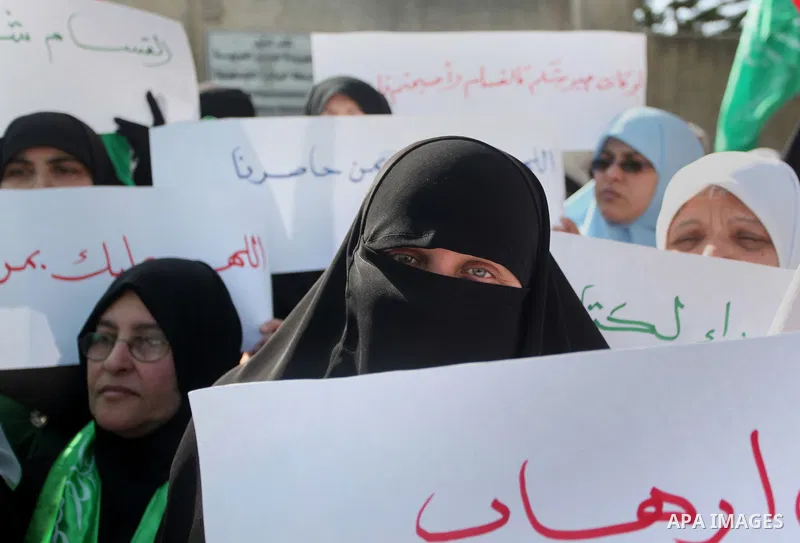 Palestinian women take part in a protest to condemn the decision of an Egyptian court to ban the armed wing of Palestinian Islamist movement, outside the Egyptian embassy in Gaza City February 9, 2015. Since Egypt's mili...