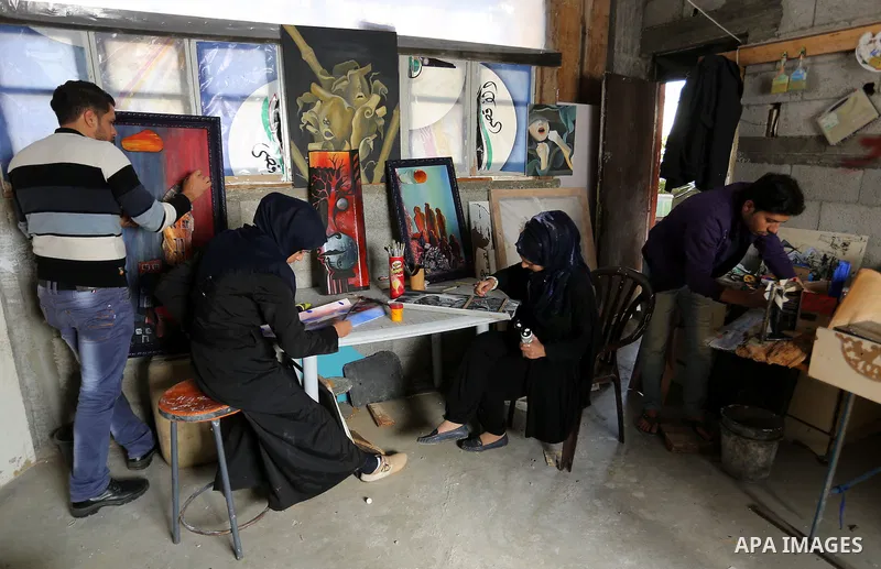 Palestinians paint pictures at an atelier in Rafah in the southern Gaza Strip, February 9, 2015. Three Palestinian artists use the remains of houses which were destroyed during the 51 day Israeli recent war on Gaza Strip...