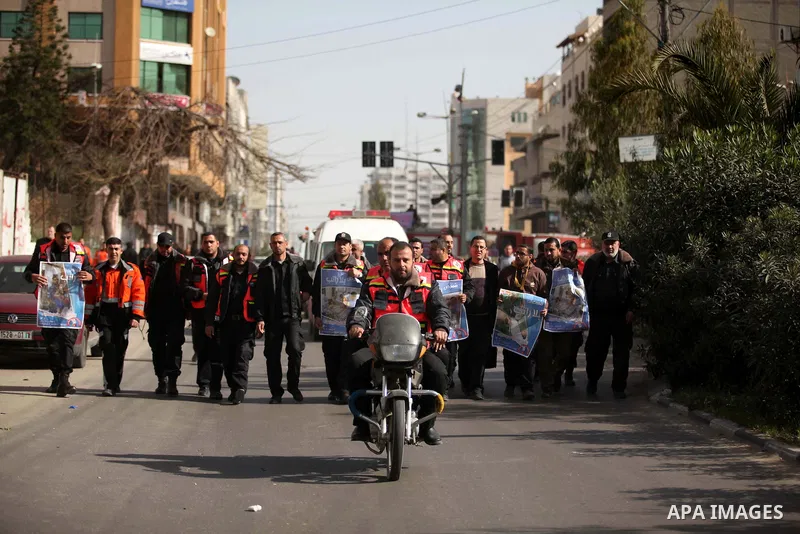 Palestinian employees of Civil defense march on a streets during a protest to demanding their salaries, in Gaza city, on February 10, 2015. Photo by Ashraf Amra