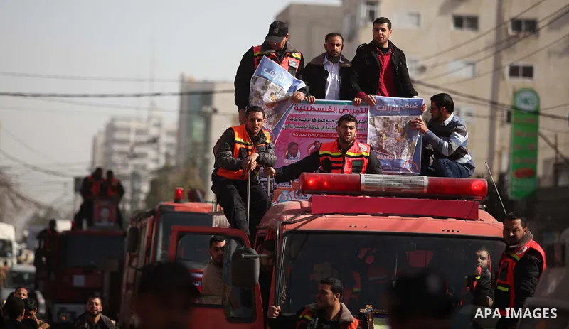 Palestinian employees of Civil defense march on a streets during a protest to demanding their salaries, in Gaza city, on February 10, 2015. Photo by Ashraf Amra