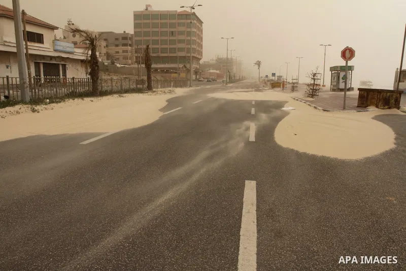 A sandstorm is in a street in Gaza city on February 11, 2015. Photo by Mohammed Asad