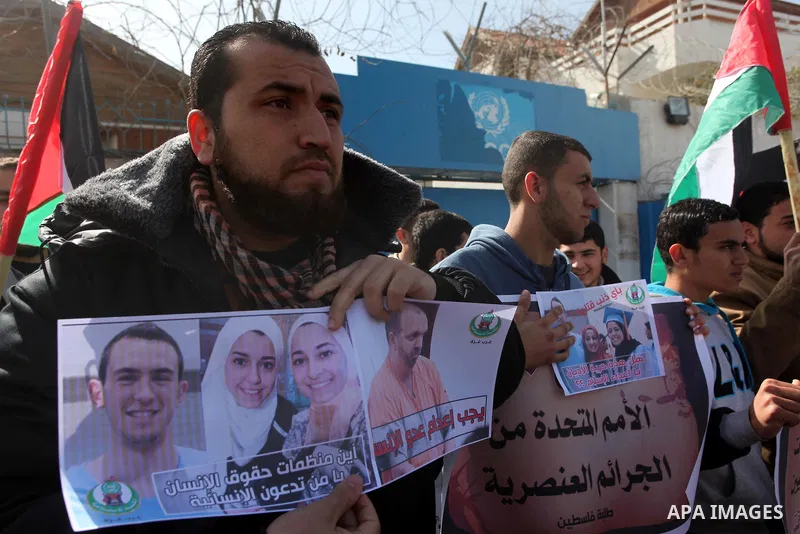 Palestinians take part in a protest against the murders of three Muslim students in Carolina, outside the UN headquarters in Gaza city on February 12, 2015. Craig Stephen Hicks, 46, has been charged with three counts of...