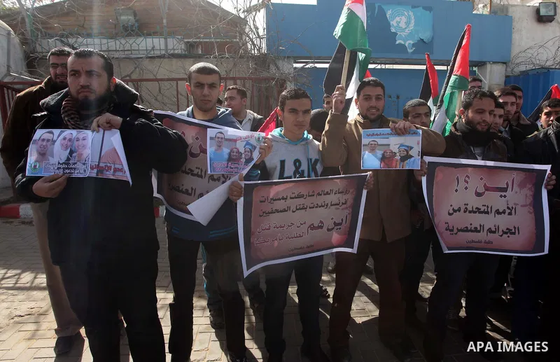 Palestinians take part in a protest against the murders of three Muslim students in Carolina, outside the UN headquarters in Gaza city on February 12, 2015. Craig Stephen Hicks, 46, has been charged with three counts of...