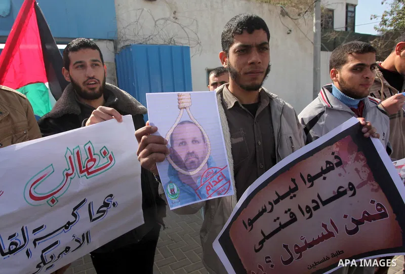 Palestinians take part in a protest against the murders of three Muslim students in Carolina, outside the UN headquarters in Gaza city on February 12, 2015. Craig Stephen Hicks, 46, has been charged with three counts of...