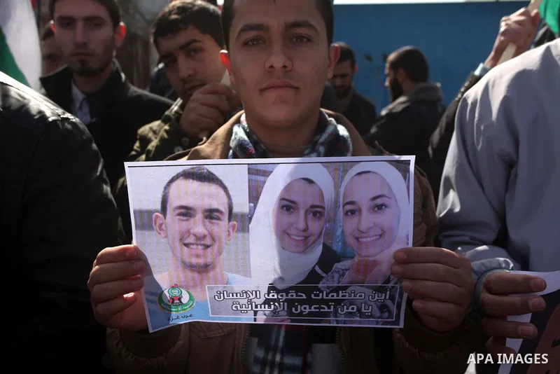 Palestinians take part in a protest against the murders of three Muslim students in Carolina, outside the UN headquarters in Gaza city on February 12, 2015. Craig Stephen Hicks, 46, has been charged with three counts of...
