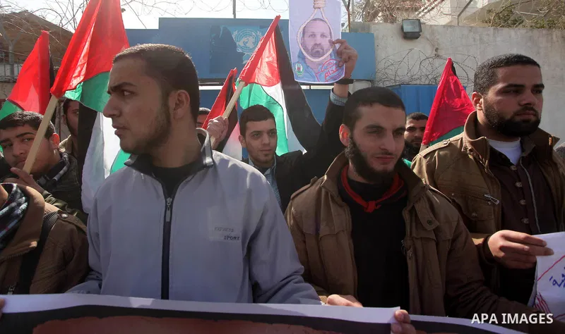 Palestinians take part in a protest against the murders of three Muslim students in Carolina, outside the UN headquarters in Gaza city on February 12, 2015. Craig Stephen Hicks, 46, has been charged with three counts of...