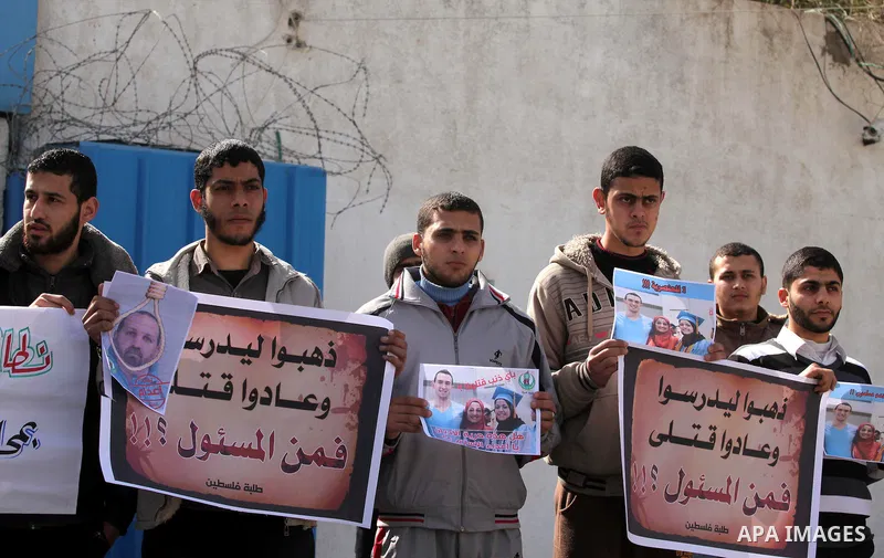 Palestinians take part in a protest against the murders of three Muslim students in Carolina, outside the UN headquarters in Gaza city on February 12, 2015. Craig Stephen Hicks, 46, has been charged with three counts of...