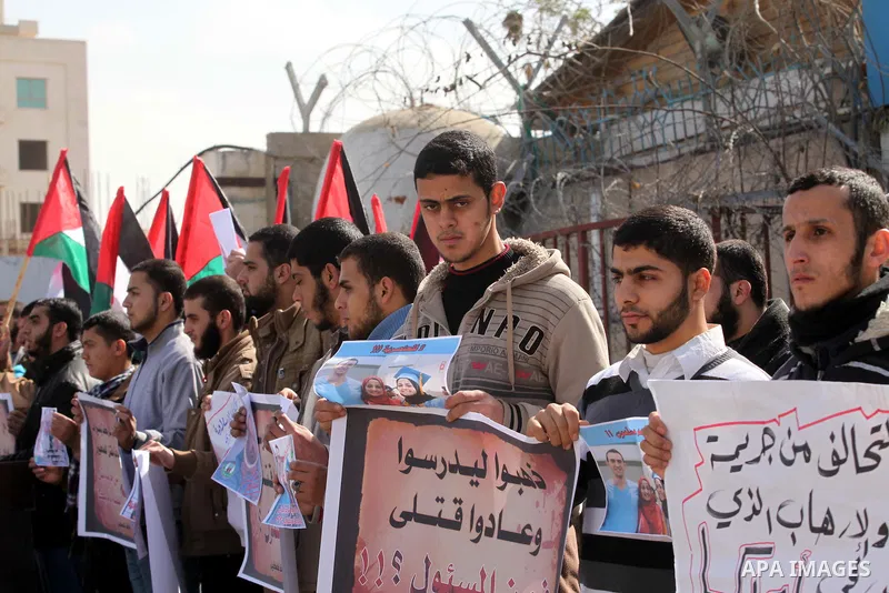 Palestinians take part in a protest against the murders of three Muslim students in Carolina, outside the UN headquarters in Gaza city on February 12, 2015. Craig Stephen Hicks, 46, has been charged with three counts of...