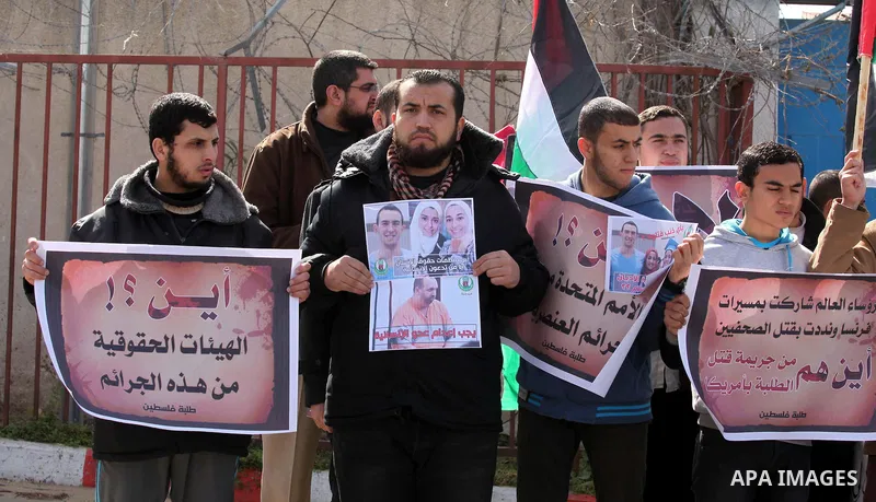 Palestinians take part in a protest against the murders of three Muslim students in Carolina, outside the UN headquarters in Gaza city on February 12, 2015. Craig Stephen Hicks, 46, has been charged with three counts of...