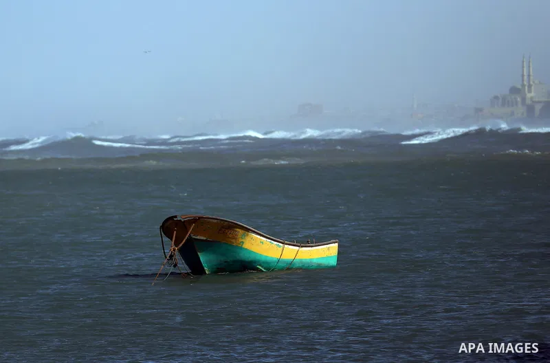 A boat is sean anchored at the Gaza seaport during a stormy day, east Gaza city on February 12, 2015. Photo by Yasser Qudih