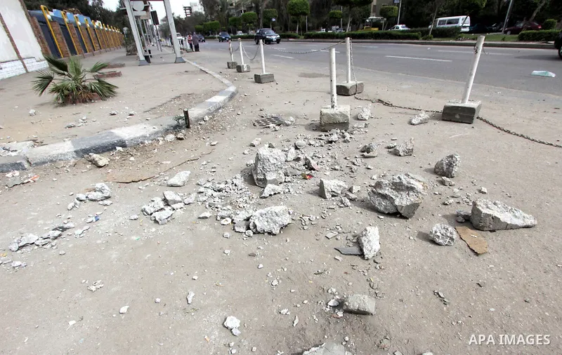 The damage is seen at site of a bomb blast in front of a police station in the Ain Shams area in Cairo, 13 February 2015. Attacks on security forces have become common in Egypt, which is currently battling an insurgency...