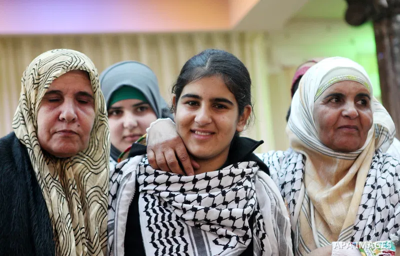 Palestinian 14-year-old schoolgirl Malak al-Khatib is greeted by relatives during a ceremony after her release from an Israeli jail, in the West Bank city of Ramallah on February 13, 2015. Israel freed Malak, whose jaili...