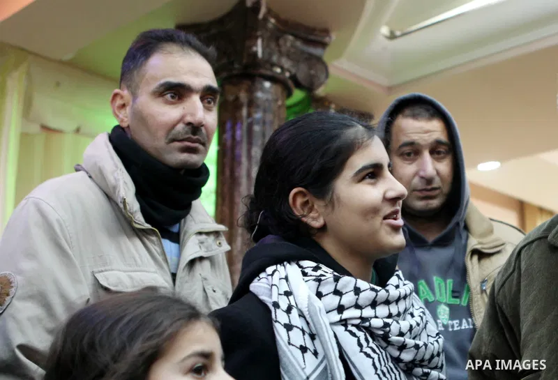 Palestinian 14-year-old schoolgirl Malak al-Khatib is greeted by relatives during a ceremony after her release from an Israeli jail, in the West Bank city of Ramallah on February 13, 2015. Israel freed Malak, whose jaili...
