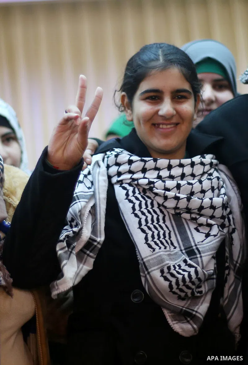 Palestinian 14-year-old schoolgirl Malak al-Khatib flashes a victory sign during a ceremony after her release from an Israeli jail, in the West Bank city of Ramallah on February 13, 2015. Israel freed Malak, whose jailin...