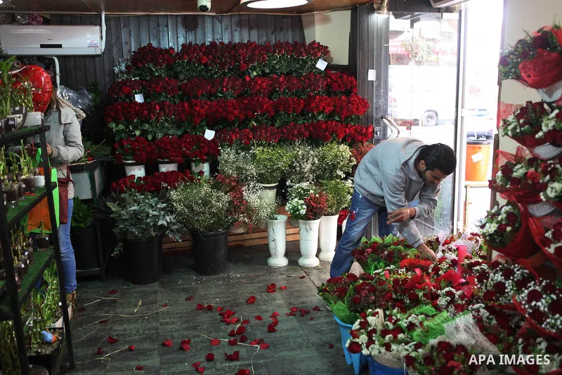 A Palestinian vendor sells a flowers on Valentine's day at his shop in the West Bank city of Ramallah, on Feb. 14, 2015. Valentine's Day is increasingly popular among younger Palestinians, many of whom have taken up the...