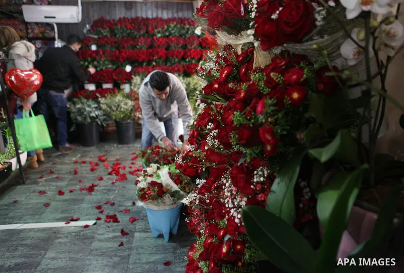A Palestinian vendor sells a flowers on Valentine's day at his shop in the West Bank city of Ramallah, on Feb. 14, 2015. Valentine's Day is increasingly popular among younger Palestinians, many of whom have taken up the...