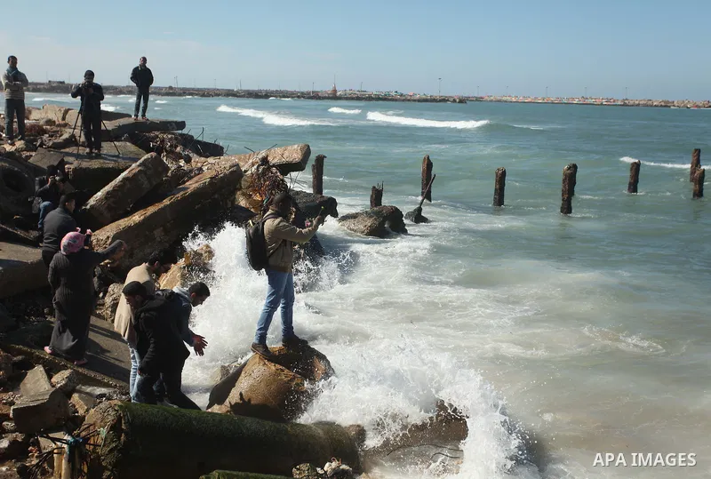 Palestinians throw flowers into the sea, in remembrance of the Chapel Hill shooting victims, in Gaza City, February 14, 2015. Three young Muslims were gunned down in Chapel Hill, North Carolina, this week. Newlywed Deah...