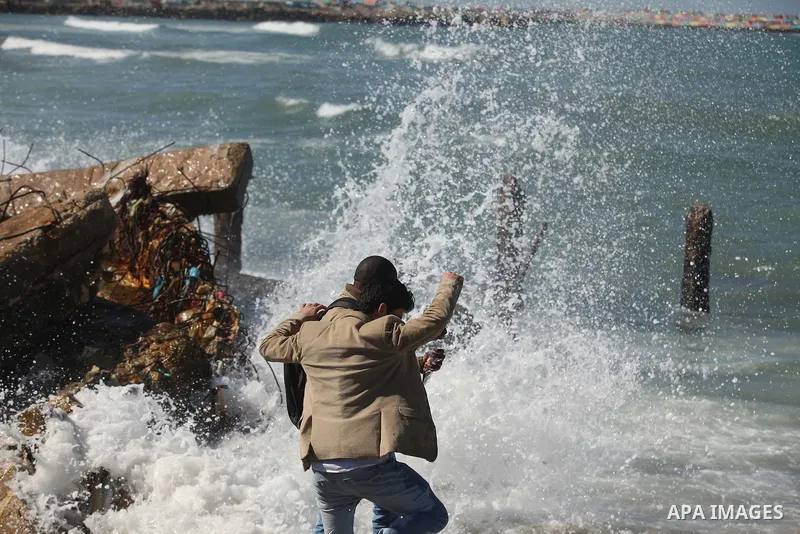 Palestinians throw flowers into the sea, in remembrance of the Chapel Hill shooting victims, in Gaza City, February 14, 2015. Three young Muslims were gunned down in Chapel Hill, North Carolina, this week. Newlywed Deah...