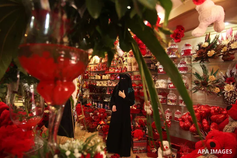 A Palestinian woman shops at a store displaying red teddy bears and pillows on Valentine's day in Gaza on February 14, 2015. Valentine's Day is increasingly popular in the region as people have taken up the custom of giv...