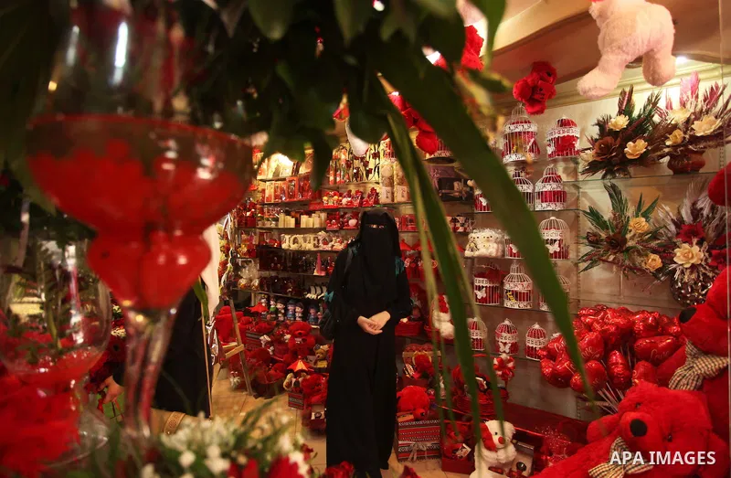 A Palestinian woman shops at a store displaying red teddy bears and pillows on Valentine's day in Gaza on February 14, 2015. Valentine's Day is increasingly popular in the region as people have taken up the custom of giv...