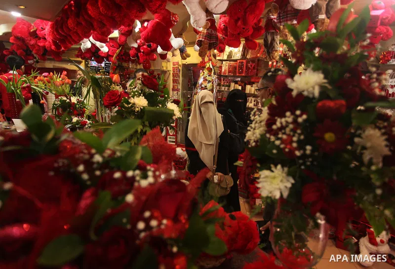 A Palestinian woman shops at a store displaying red teddy bears and pillows on Valentine's day in Gaza on February 14, 2015. Valentine's Day is increasingly popular in the region as people have taken up the custom of giv...