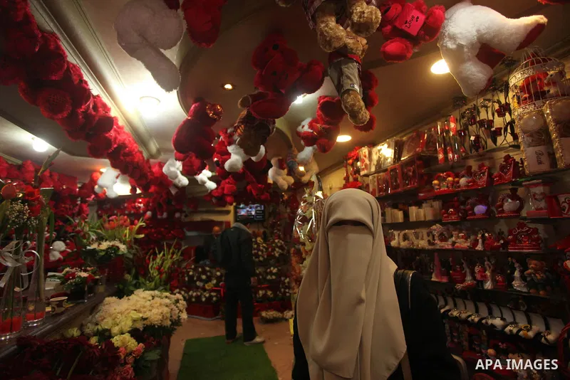 A Palestinian woman shops at a store displaying red teddy bears and pillows on Valentine's day in Gaza on February 14, 2015. Valentine's Day is increasingly popular in the region as people have taken up the custom of giv...