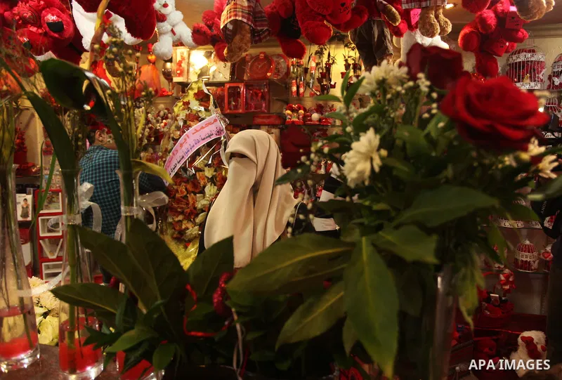 A Palestinian woman shops at a store displaying red teddy bears and pillows on Valentine's day in Gaza on February 14, 2015. Valentine's Day is increasingly popular in the region as people have taken up the custom of giv...