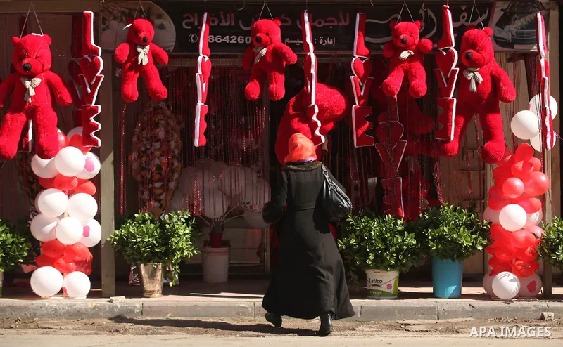 A Palestinian woman shops at a store displaying red teddy bears and pillows on Valentine's day in Gaza on February 14, 2015. Valentine's Day is increasingly popular in the region as people have taken up the custom of giv...