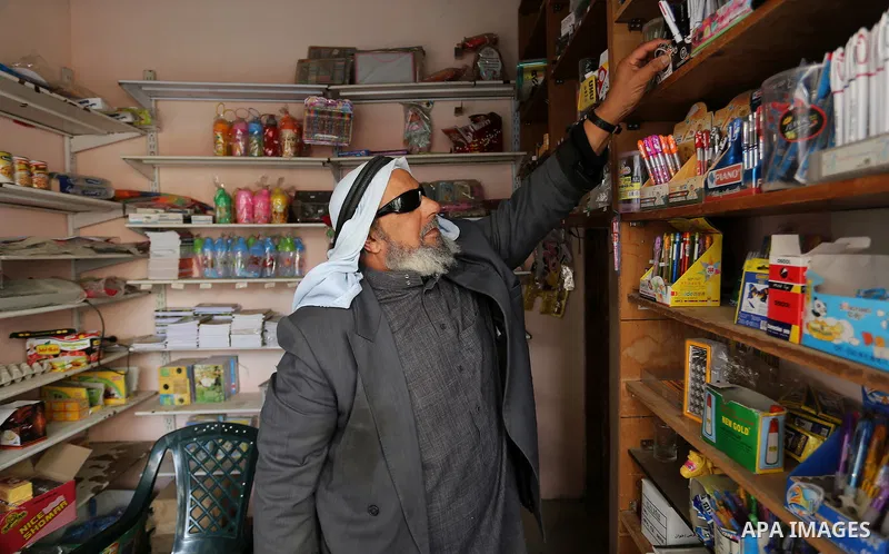 A Palestinian man displays goods at his shop in Rafah in the southern Gaza strip, on February 14, 2015. Refugee unemployment in Gaza reached 45.5% in the second quarter of 2014, the highest level ever reported in UNRWA’s...