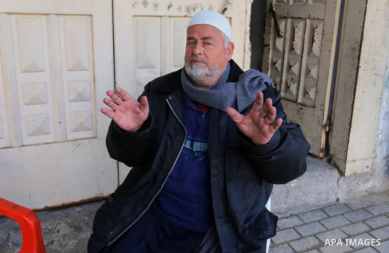 A Palestinian man sits outside his house in Rafah in the southern Gaza strip, on February 14, 2015. Refugee unemployment in Gaza reached 45.5% in the second quarter of 2014, the highest level ever reported in UNRWA’s PCB...