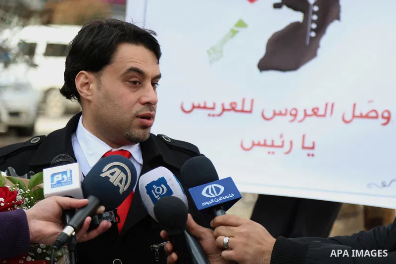 A Palestinian Rashid fedda, 35,speaks to media to demand the President Mahmoud Abbas for help him in reuniting with his fiancee, Dalia from Gaza City, during a protest, at Manara square in the West Bank town of Ramallah,...