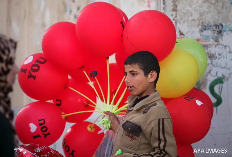 A Palestinian vendor sells red balloons on Valentine's day in Gaza on February 14, 2015. Valentine's Day is increasingly popular in the region as people have taken up the custom of giving flowers, cards, chocolates and g...