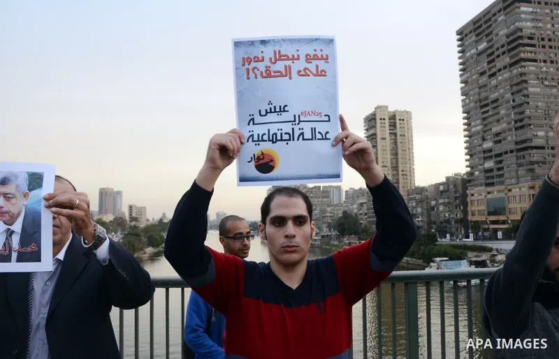 Members of the April 6 movement hold placards during a demonstration of October bridge in Cairo, Egypt on February 14, 2015. Photo by Amr Sayed